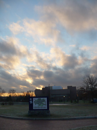 Sunrise over UConn building with campus map